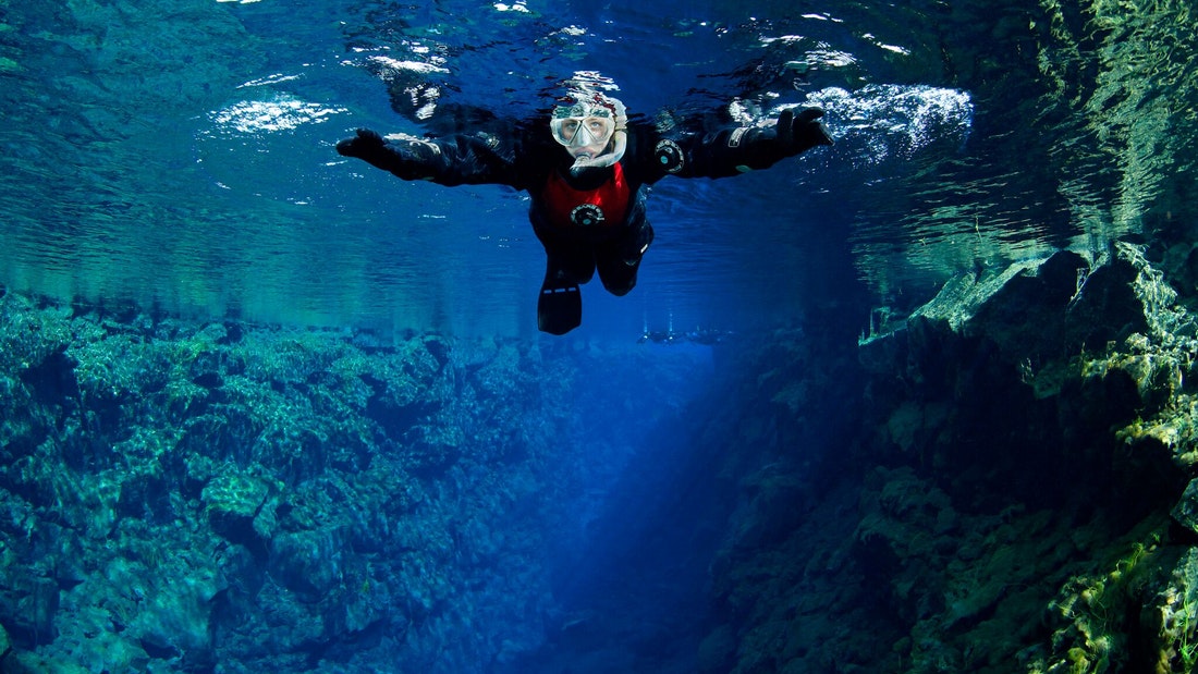 Silfra snorkeling in the clear fissure water at Thingvellir